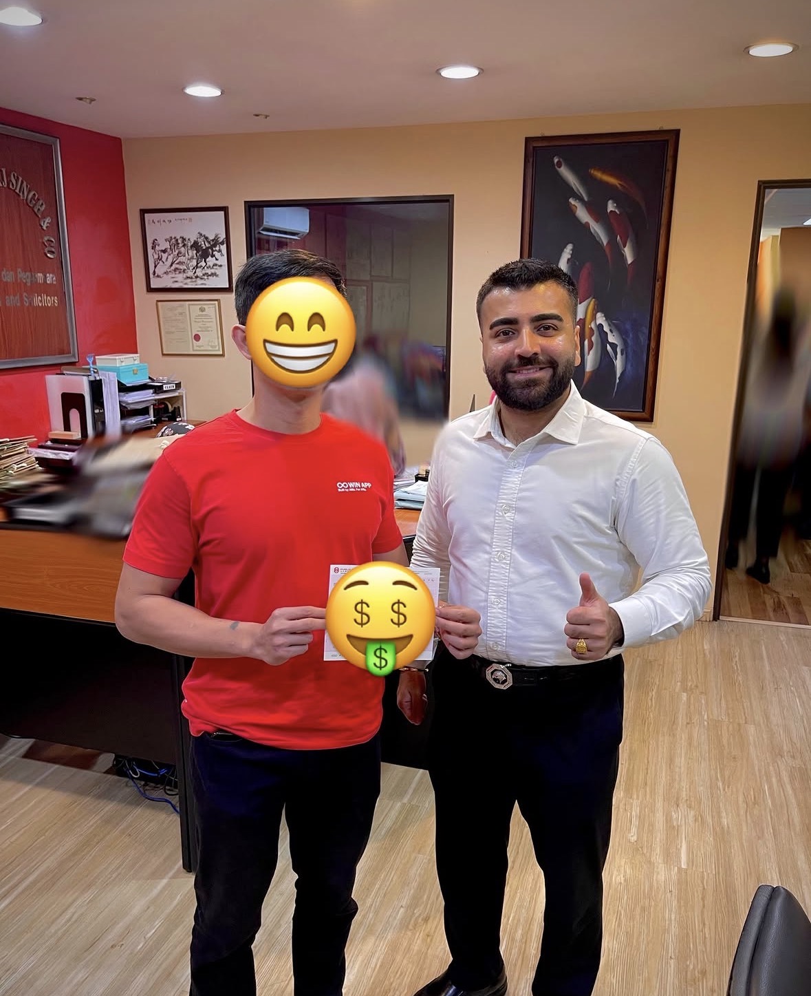 Client receiving settlement cheque at Peguam Rohan's office