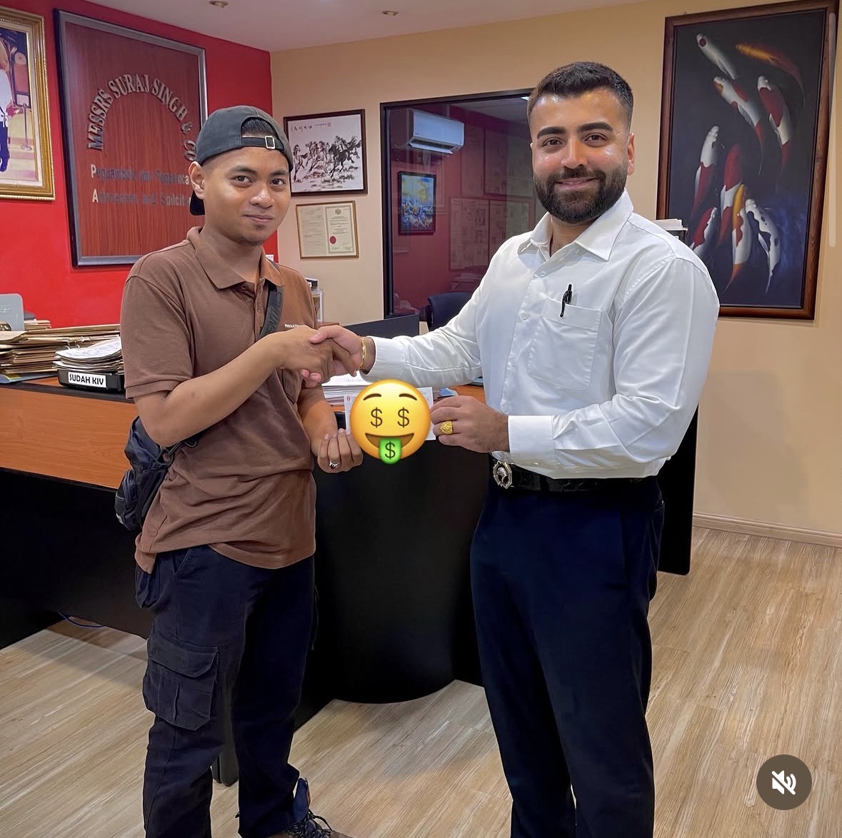 Client receiving settlement cheque at Peguam Rohan's office