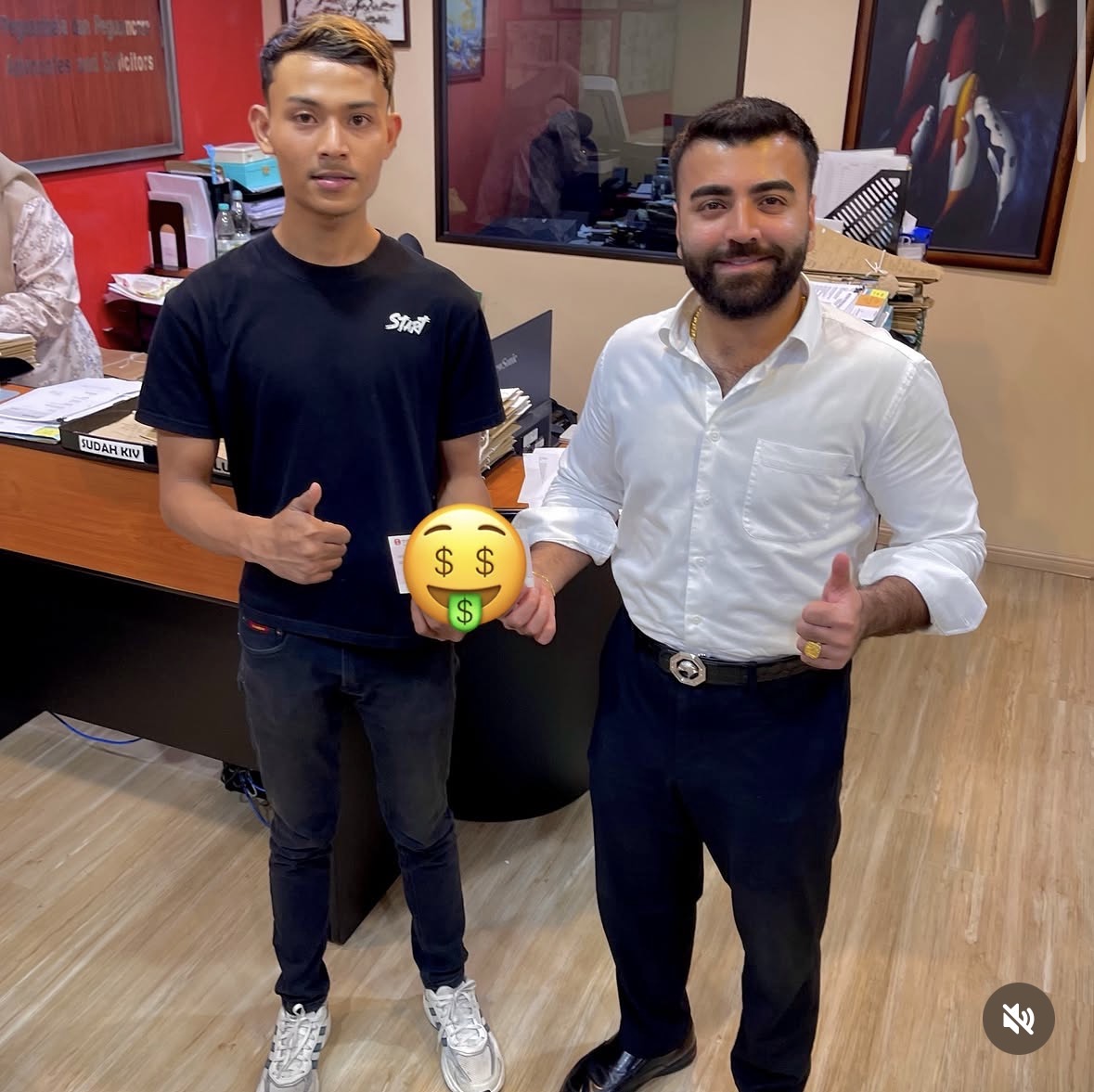 Client receiving settlement cheque at Peguam Rohan's office