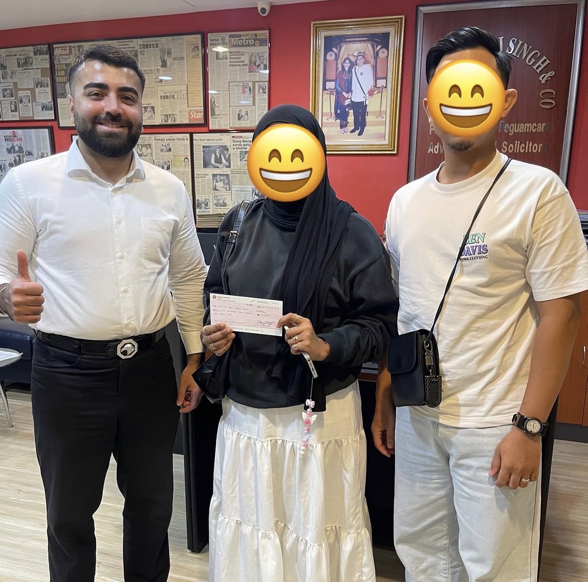 Client receiving settlement cheque at Peguam Rohan's office