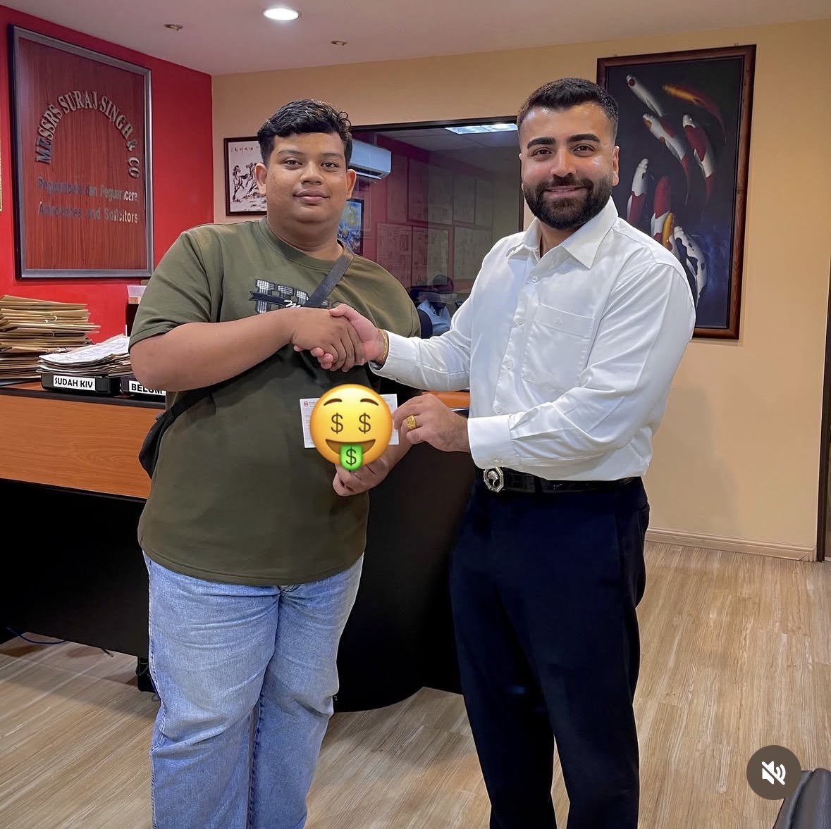 Client receiving settlement cheque at Peguam Rohan's office